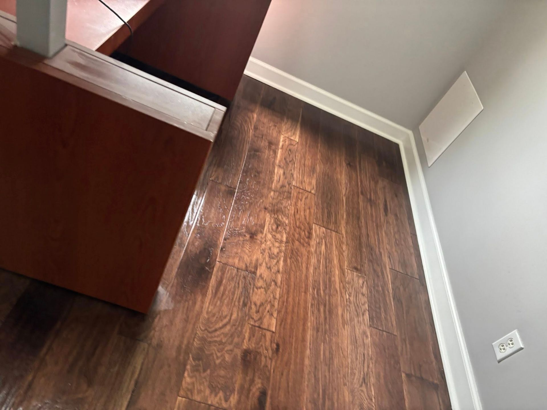 A room with a wooden floor and white trim.