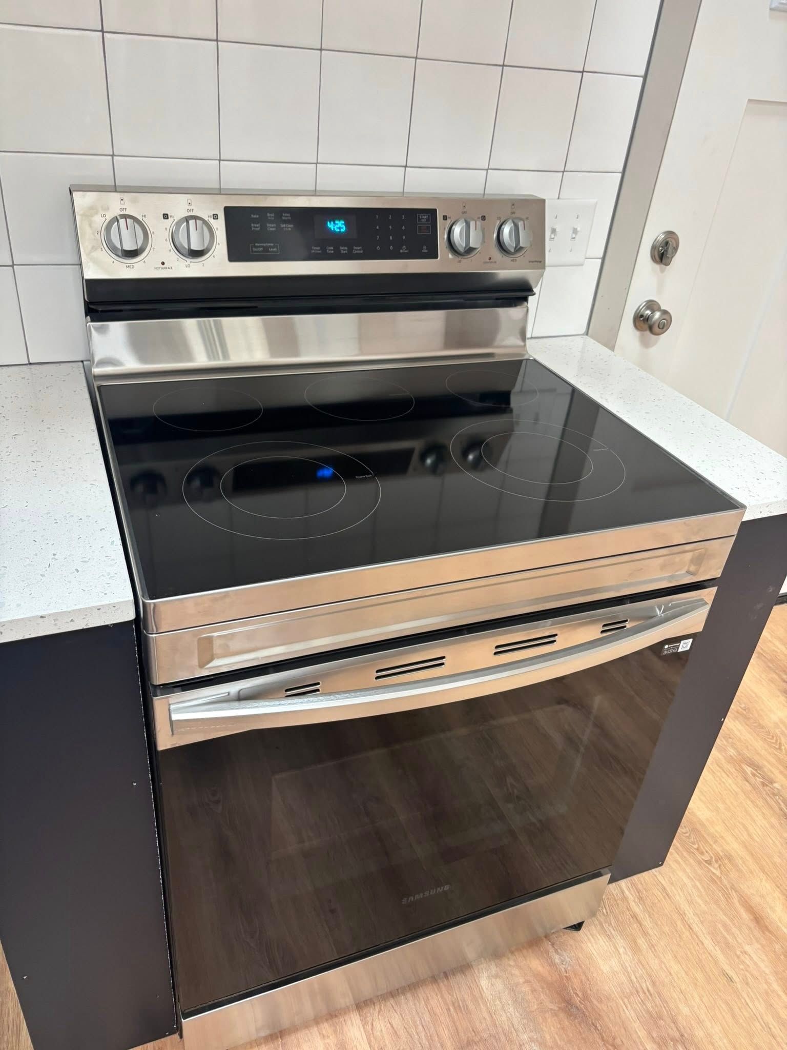 A stainless steel stove top oven is sitting on top of a counter.