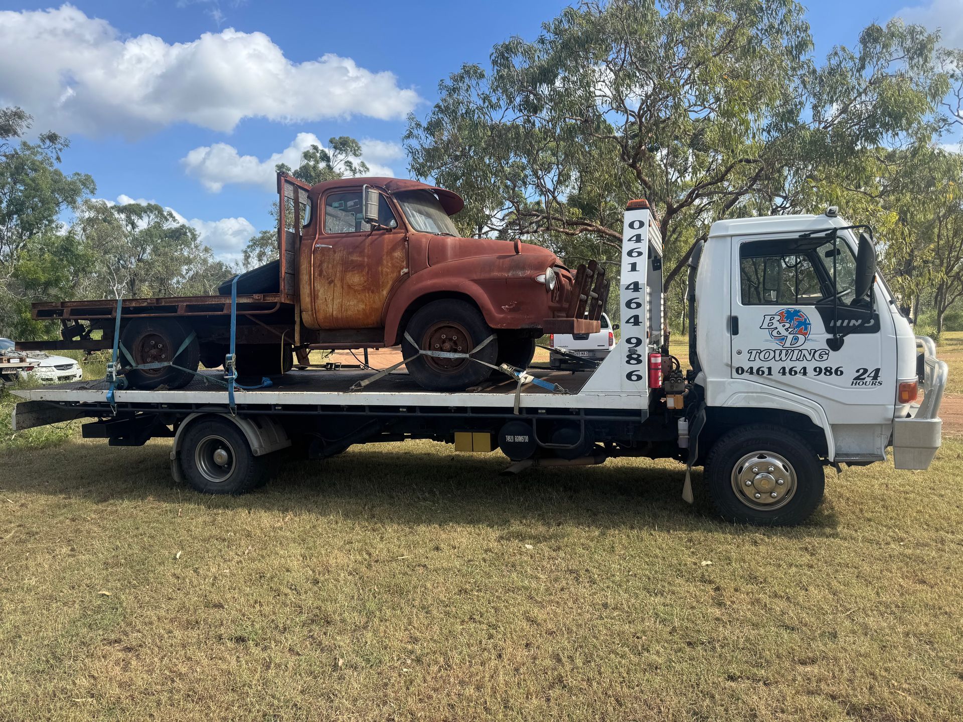 A Rusty Vintage Truck Loaded Onto a Flatbed Tow Truck — B&D Auto Group & Towing in Bowen, QLD