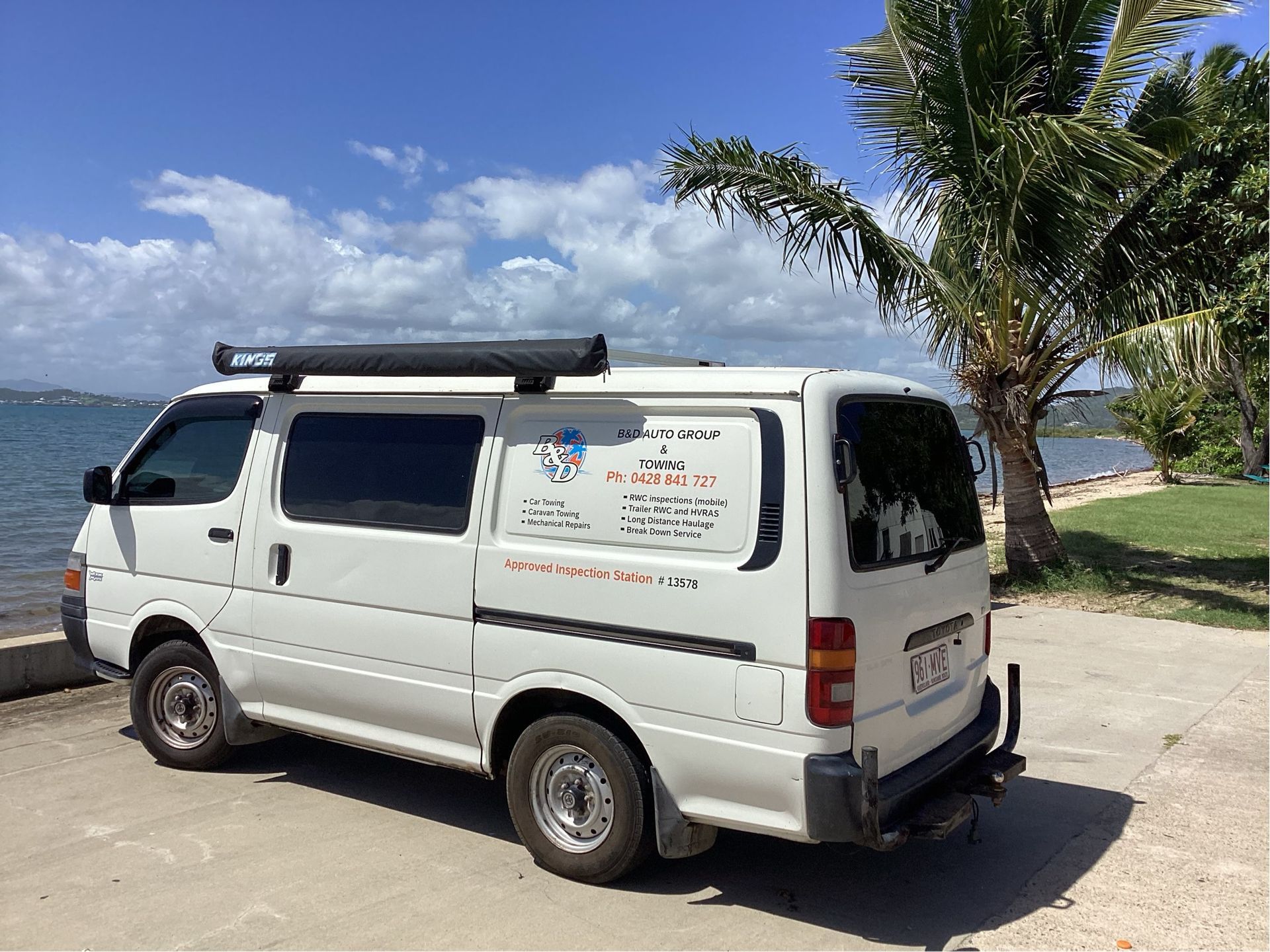 Flatbed Truck Carrying a White Vintage Car With Red Wheels — B&D Auto Group & Towing in Bowen, QLD
