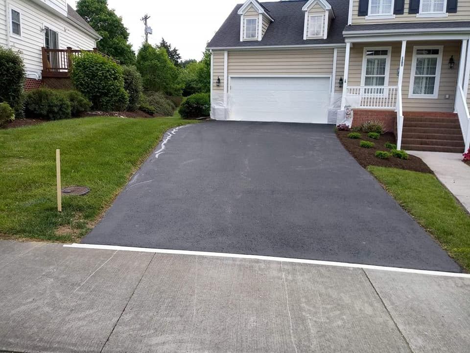 A driveway leading to a house with a white garage door