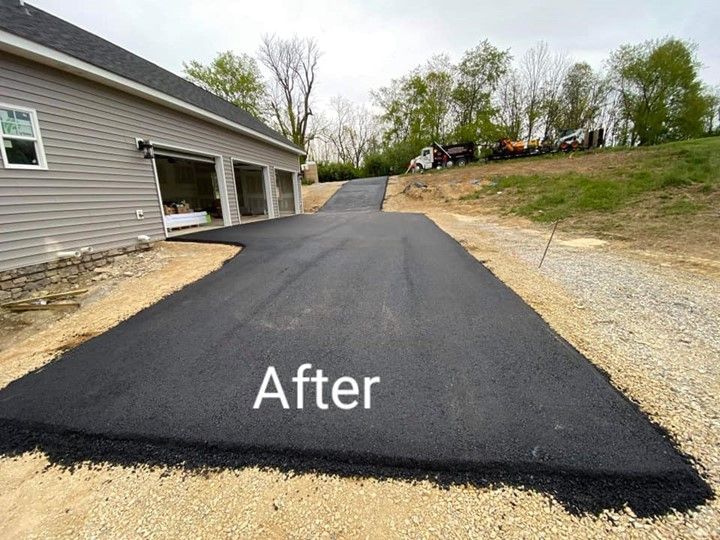 A picture of a driveway that has been paved in front of a house.