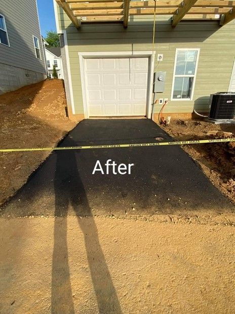 A picture of a driveway that has been paved in front of a house.