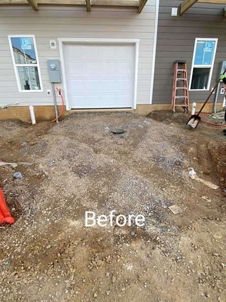A before picture of a driveway in front of a house.