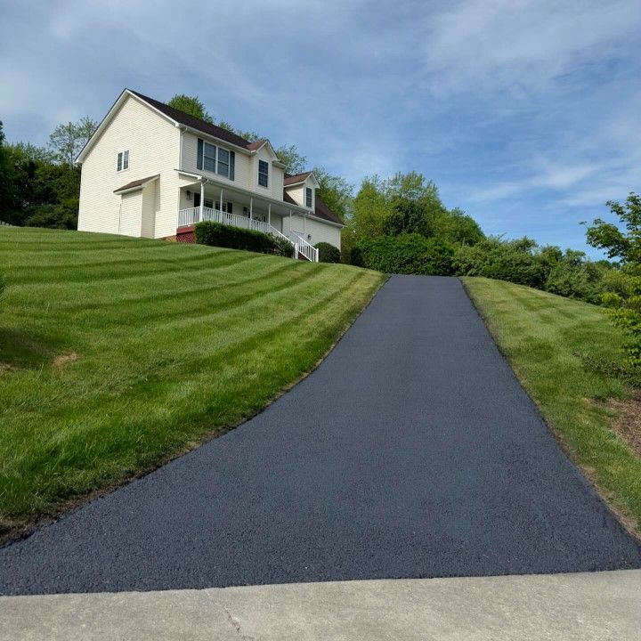A house on a hill with a driveway leading to it