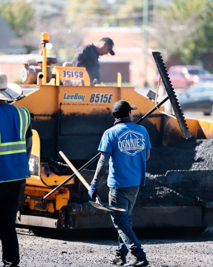 A man wearing a blue shirt that says cowboys on it