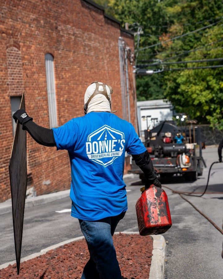 A man wearing a blue shirt that says donnie 's on it