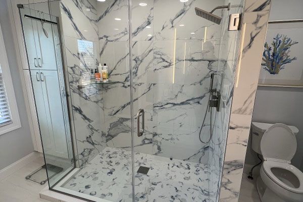 Modern bathroom with marble shower and toilet.
