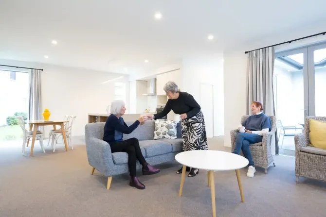 Residents enjoying coffee in shared lounge