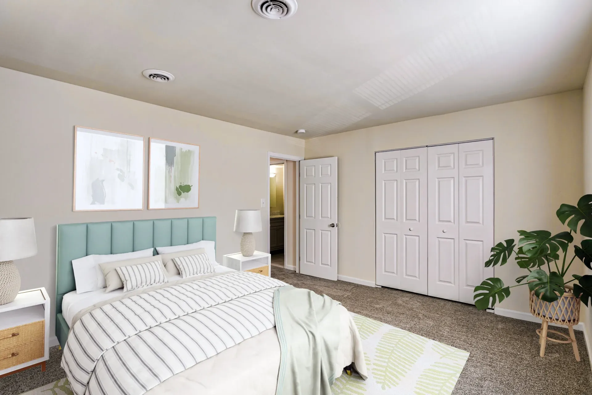 Brookbend Apartments Bedroom in a modern apartment with a bed, two nightstands, lamps, and a closet.