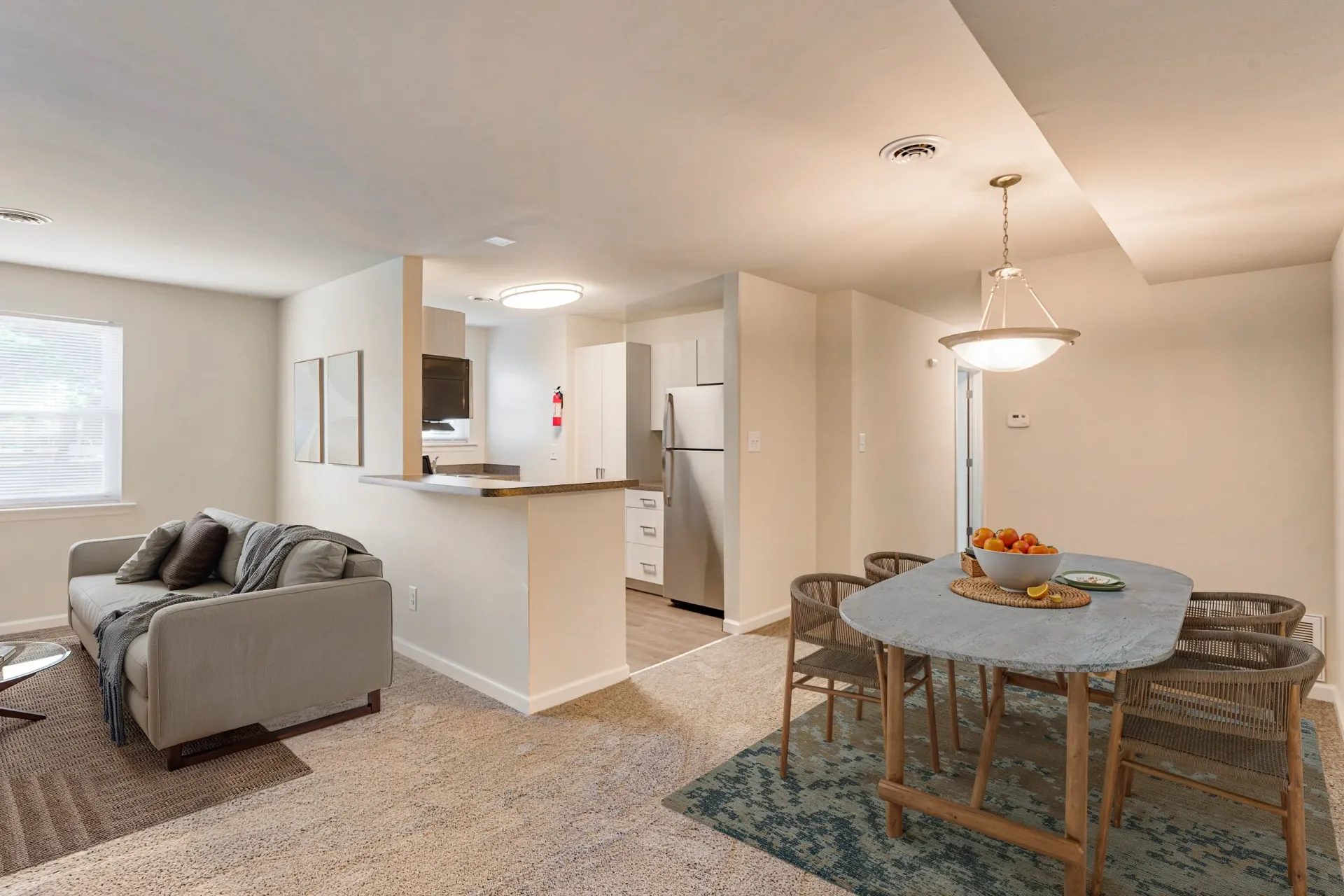 Brookbend Apartments Open-concept living room and dining area with kitchen counter and appliances.