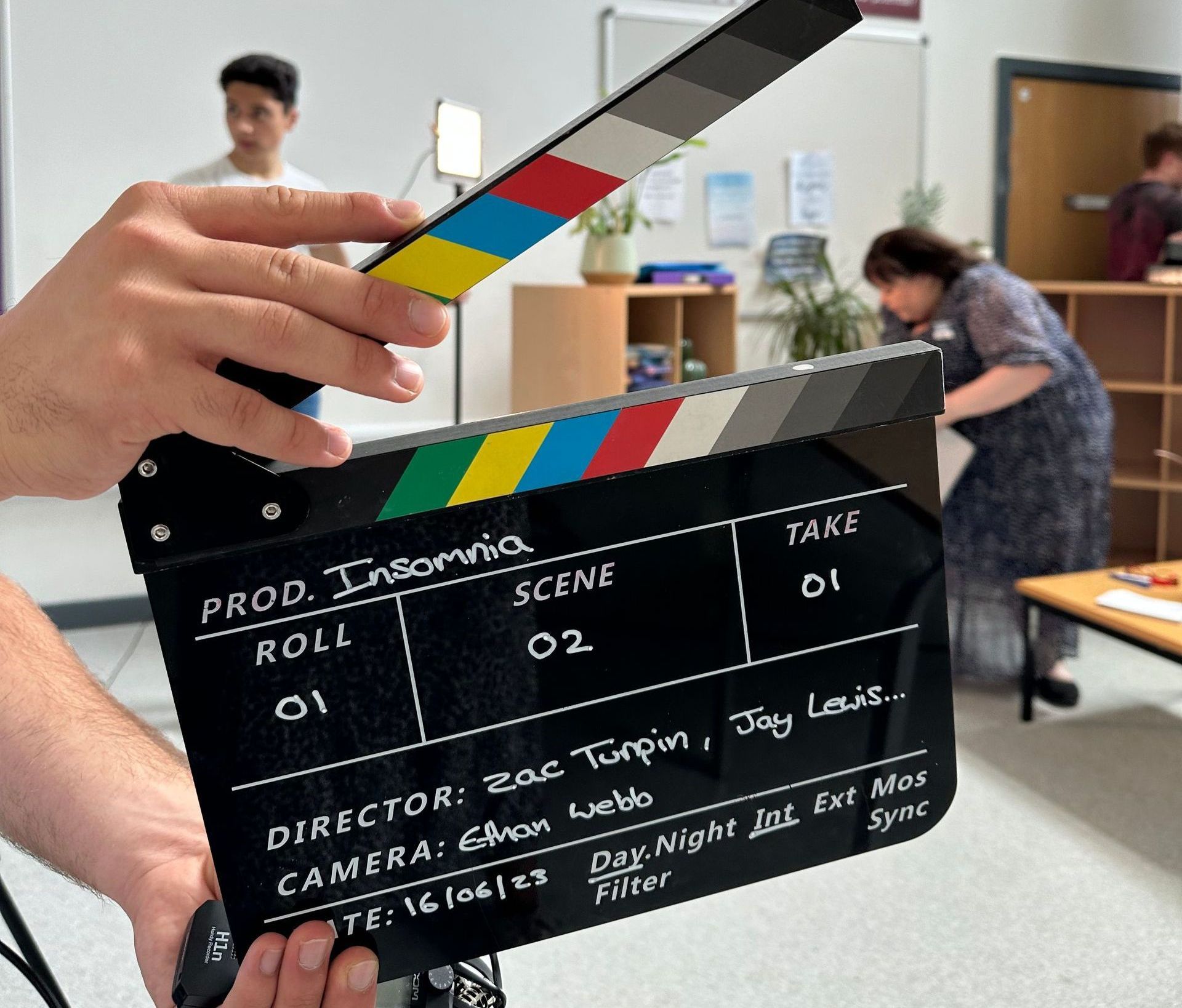 Children holding a clapper board in film classes