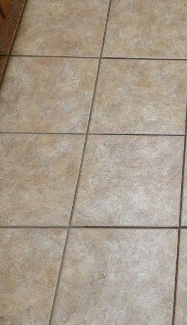 Accessible shower with built-in bench, grab bar, multiple shower heads, and tiled walls/floor.