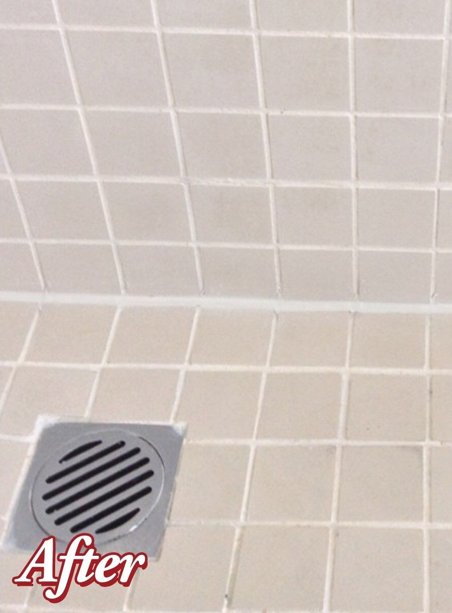 Accessible beige tiled shower with bench, grab bar, multiple shower heads and fixtures.