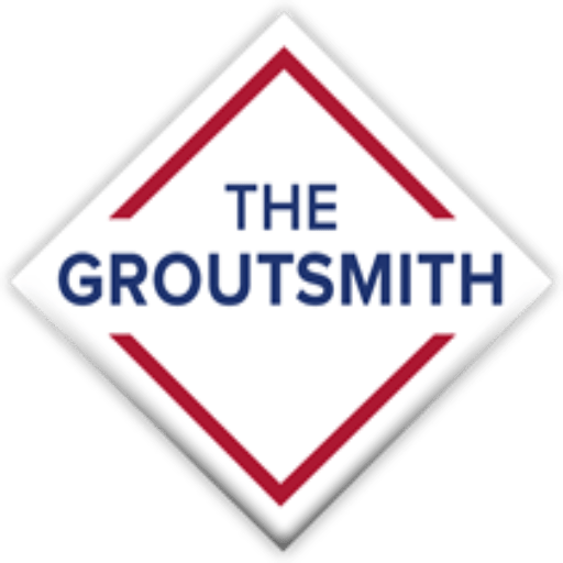 Logo for The Groutsmith, white diamond with red and blue text.