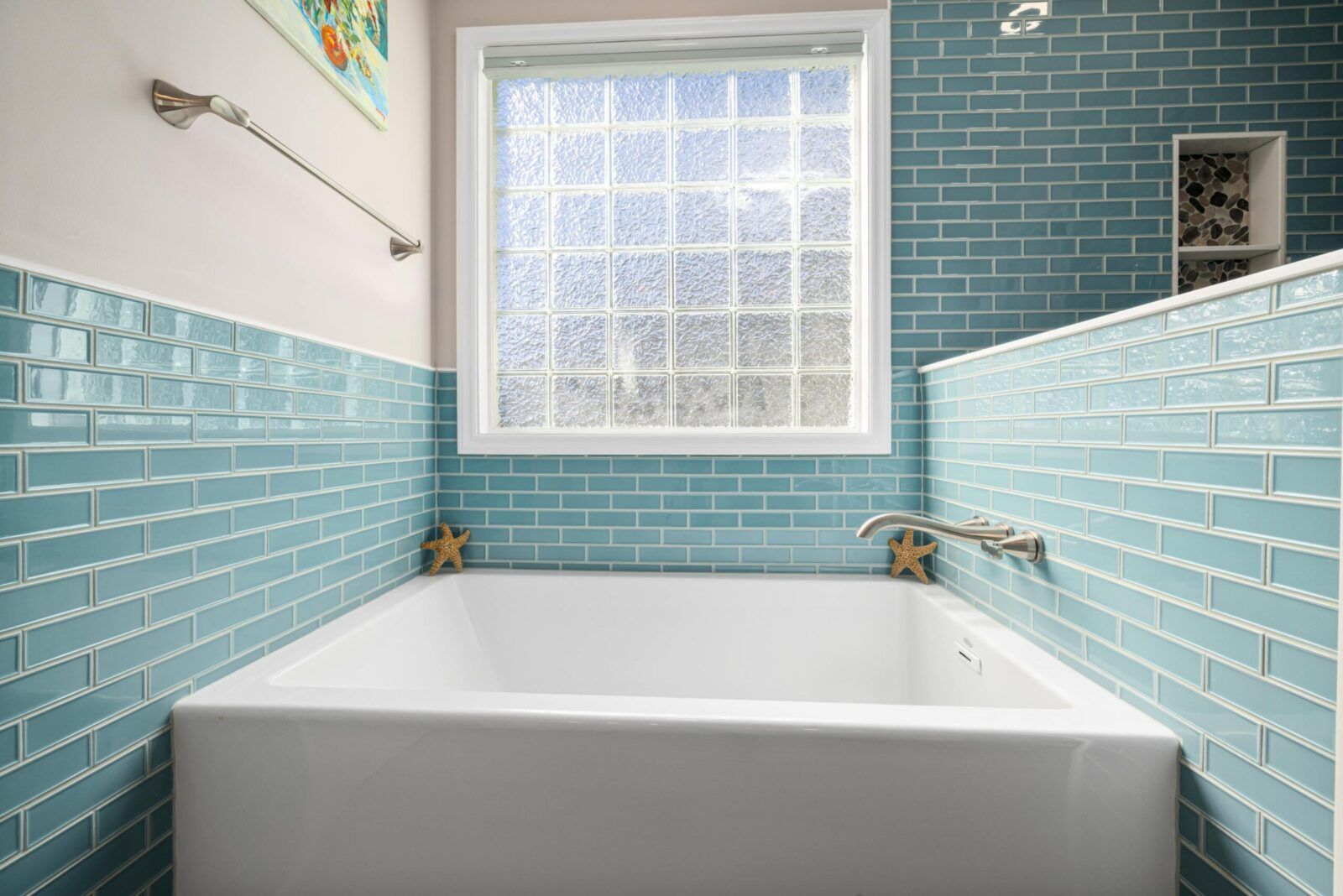 Person cleaning white tile floor with a machine.