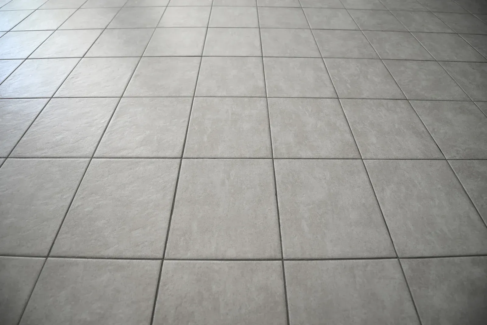 Gray tiled floor, perspective view.