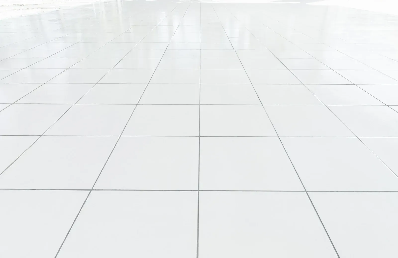 White tiled floor, perspective view with receding lines.