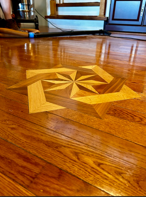 A wooden floor with a geometric pattern on it