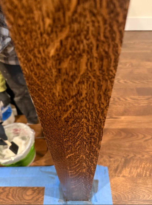 A piece of wood is sitting on a wooden floor.