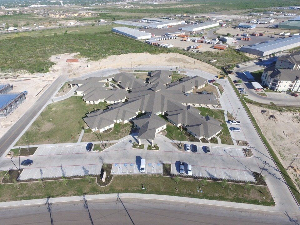 White Houses With Cars Park At The Parking Lot - Eagle Pass, TX - A.E. Hiller & Sons Inc.