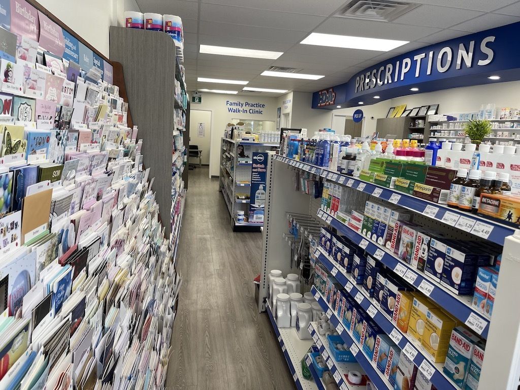 A pharmacy aisle filled with lots of medications and greeting cards.