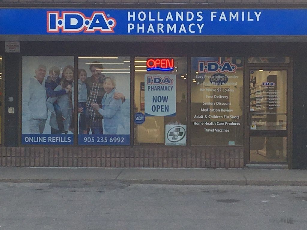 A pharmacy with a blue sign that says hollands family pharmacy