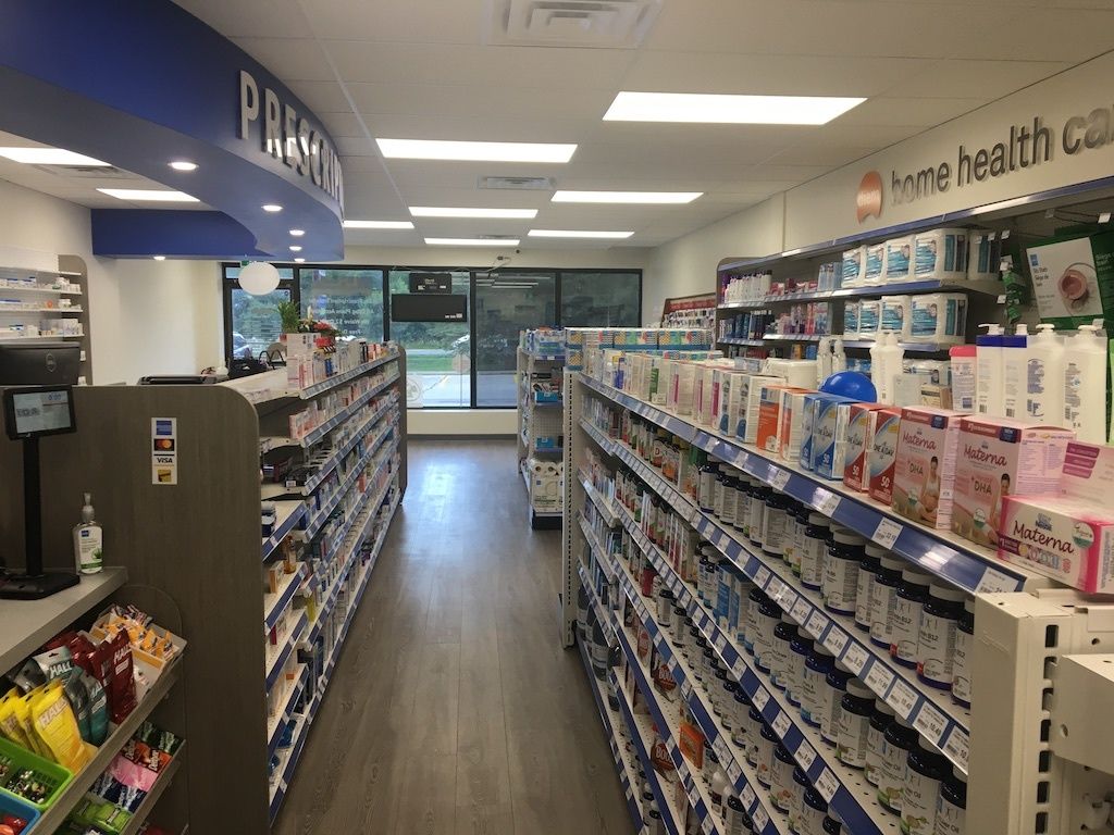 The inside of a pharmacy with lots of shelves filled with lots of products.