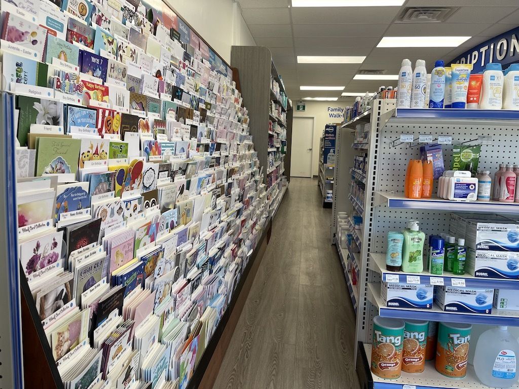 A pharmacy aisle filled with lots of cards and bottles of lotion.