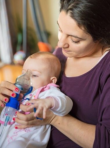 Baby with inhaler pump - Newborn health in Oxford MS