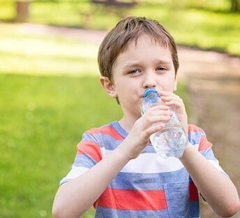 Boy drinking water- Physician in Oxford MS