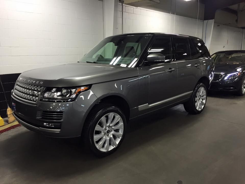 Gray Range Rover SUV parked in a garage.