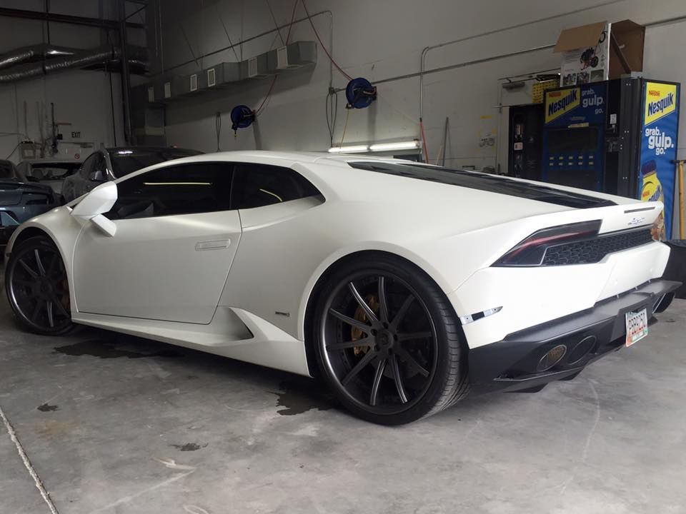 White Lamborghini sports car inside a garage.