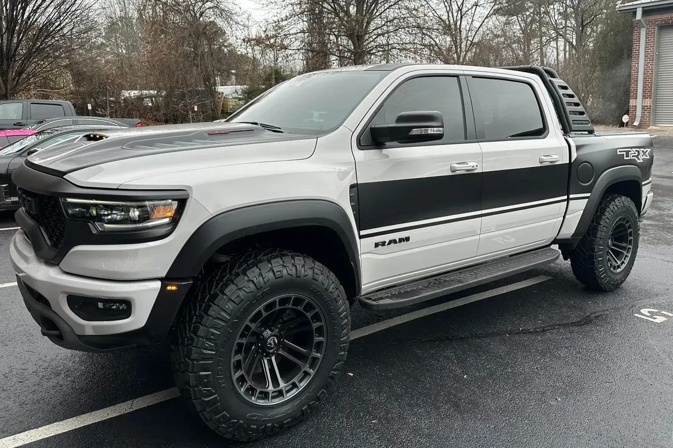 Silver and black RAM TRX truck with black accents and off-road tires.