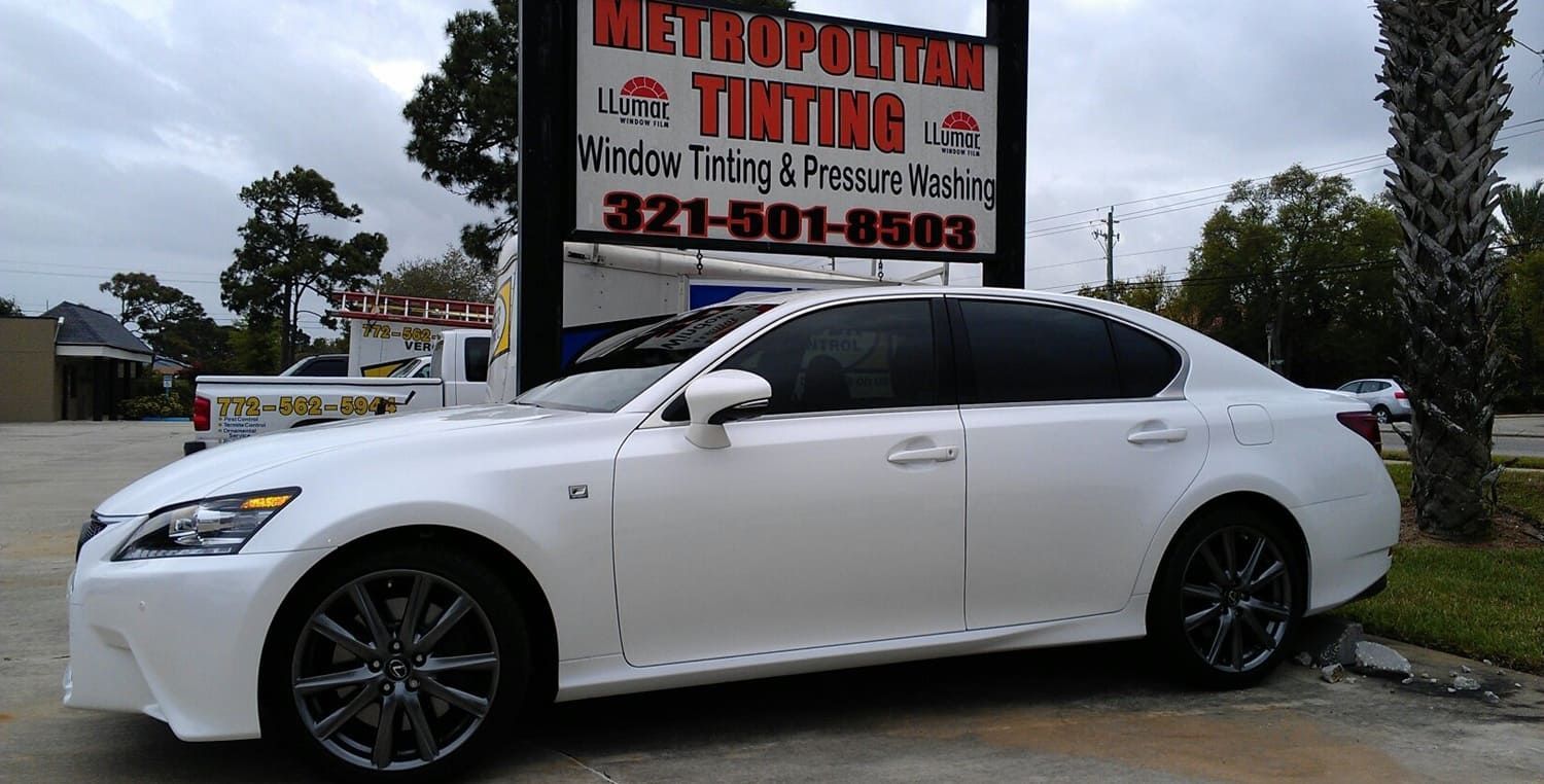 White Lexus sedan parked near a 