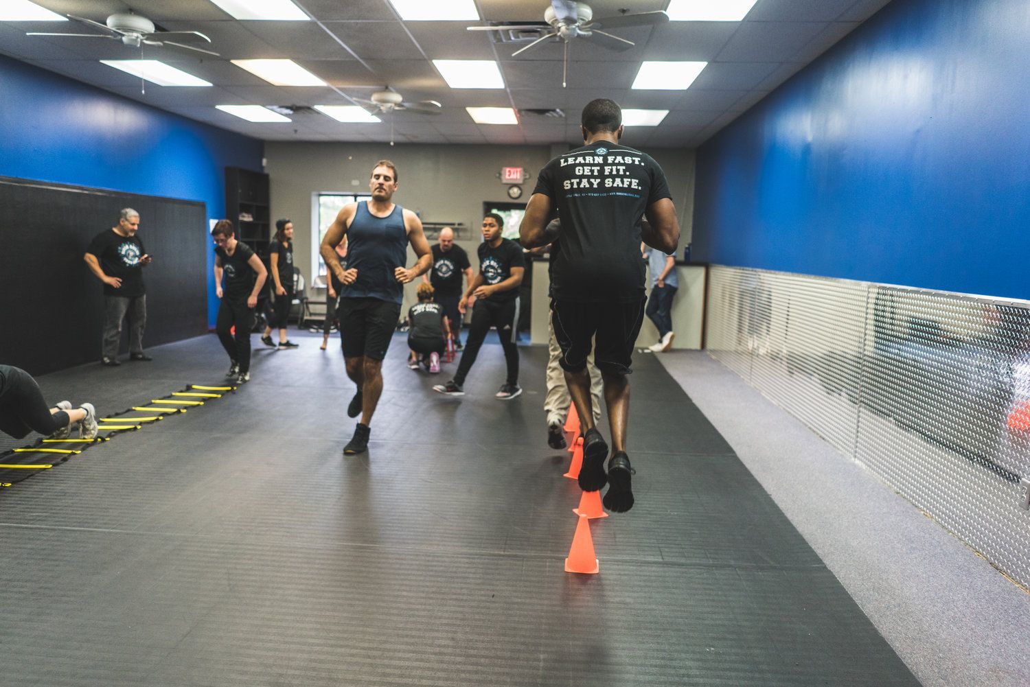 A group of people are doing exercises in a gym.
