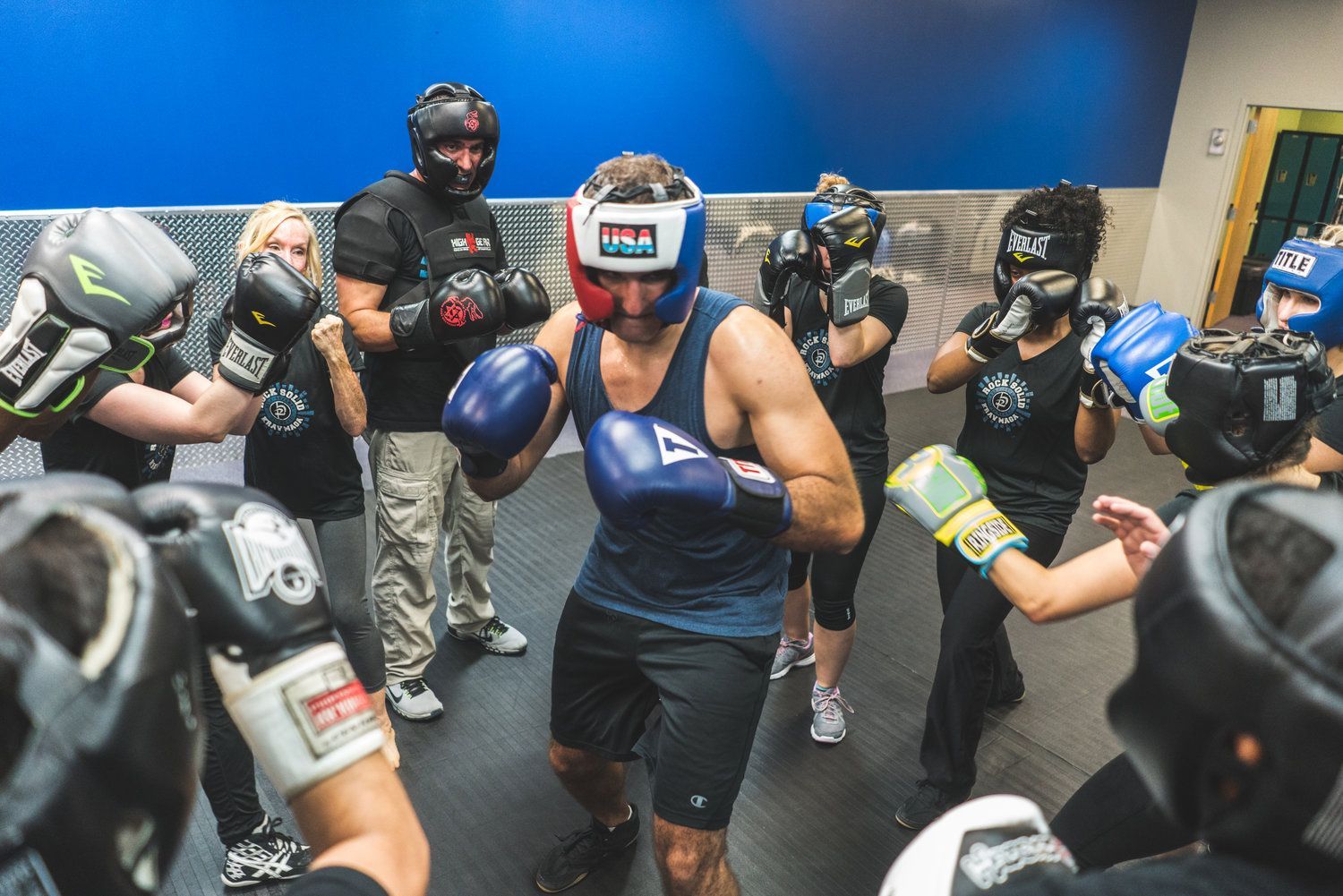 A group of people are boxing in a gym.