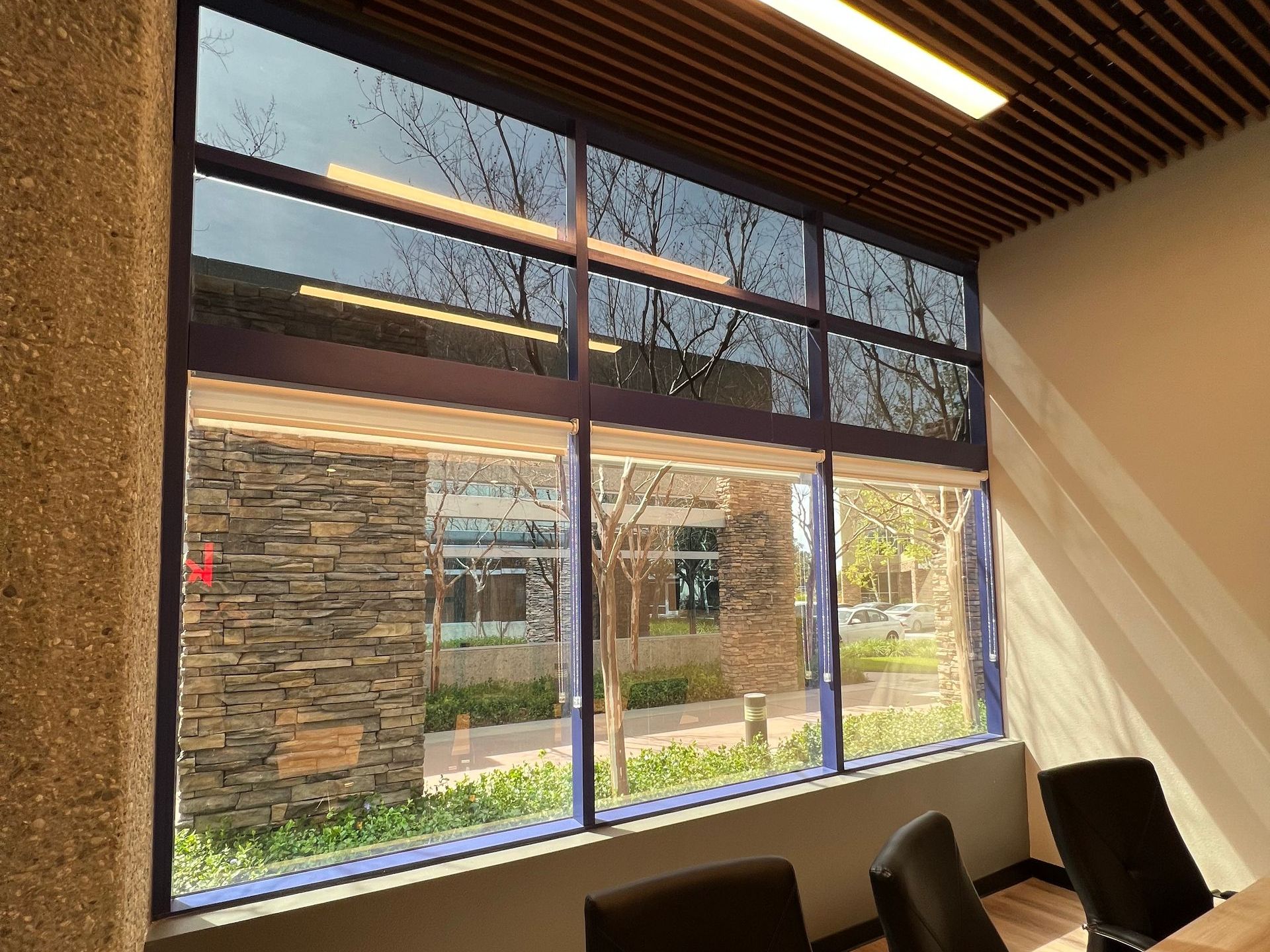 A conference room with a large window and chairs