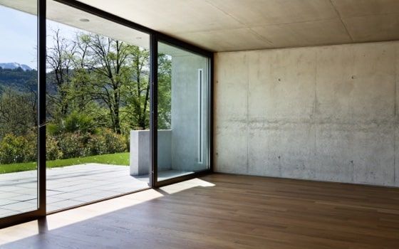 An empty room with sliding glass doors leading to a balcony.