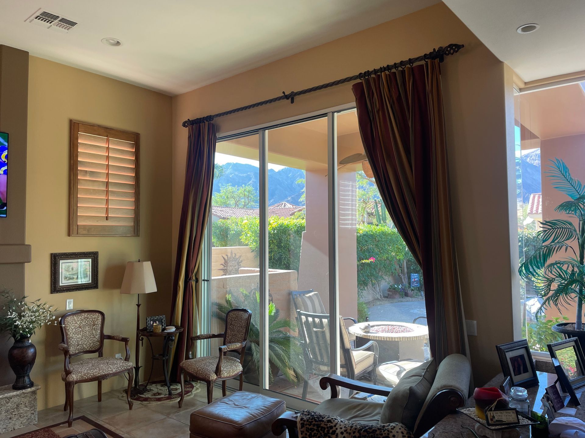 A living room with a couch and chairs and a sliding glass door