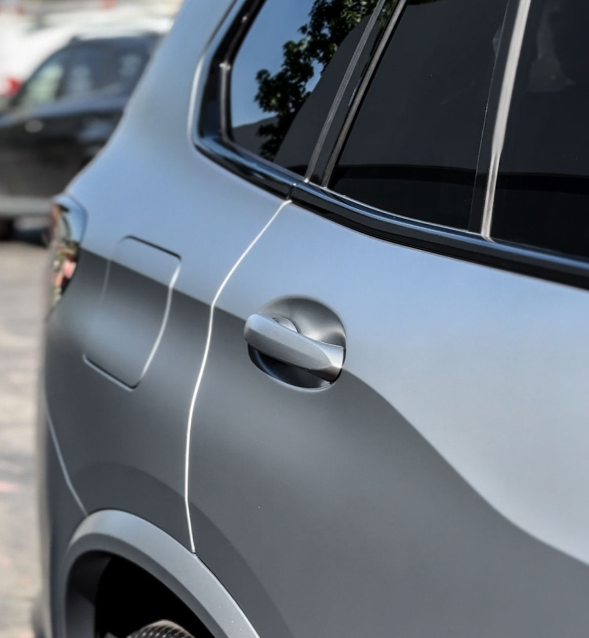 A close up of a car door with a white handle