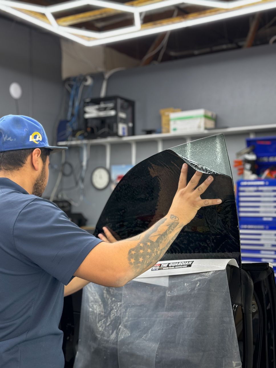A person is putting a piece of film on a window