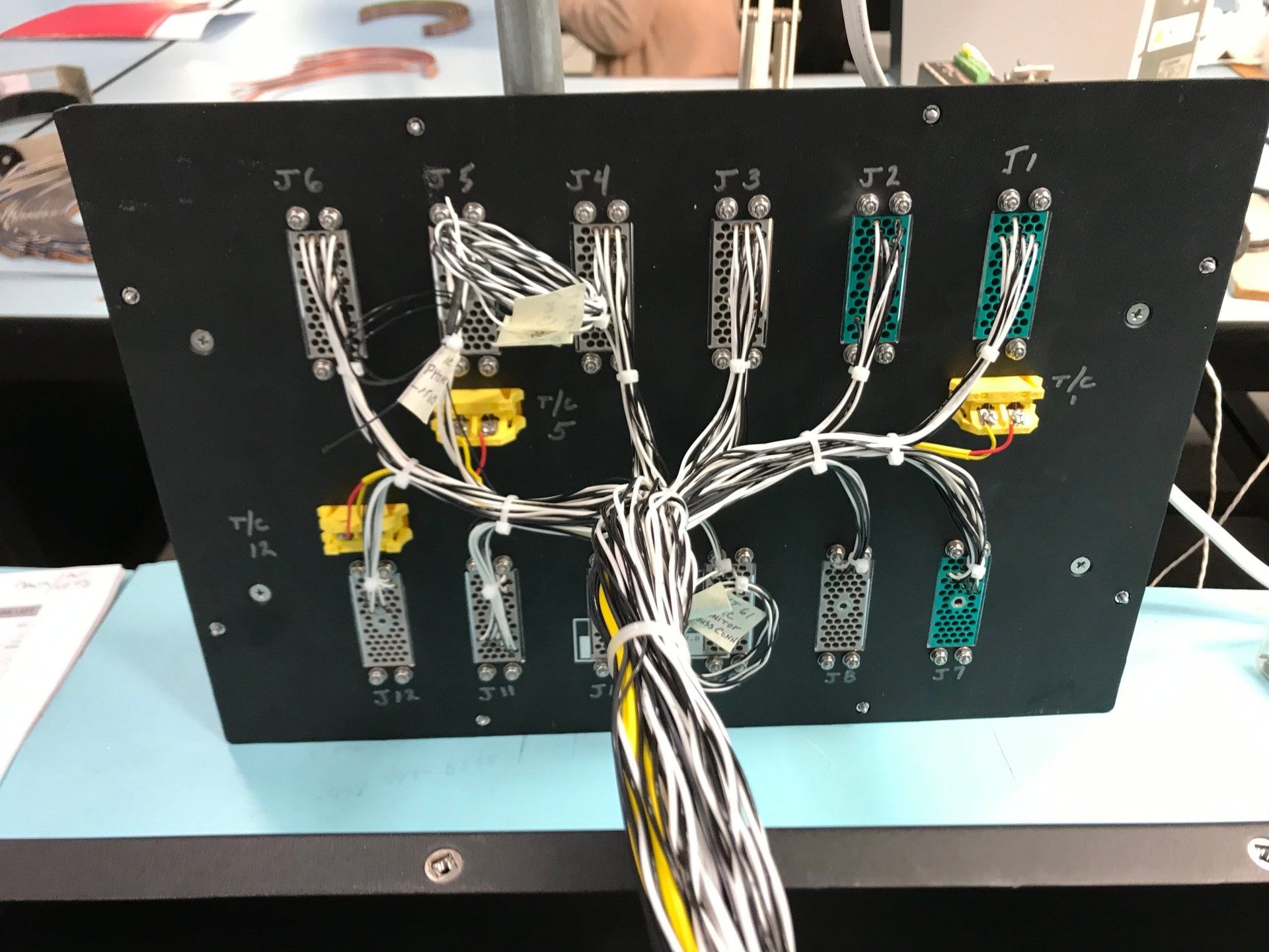 A black board with a bunch of wires on it