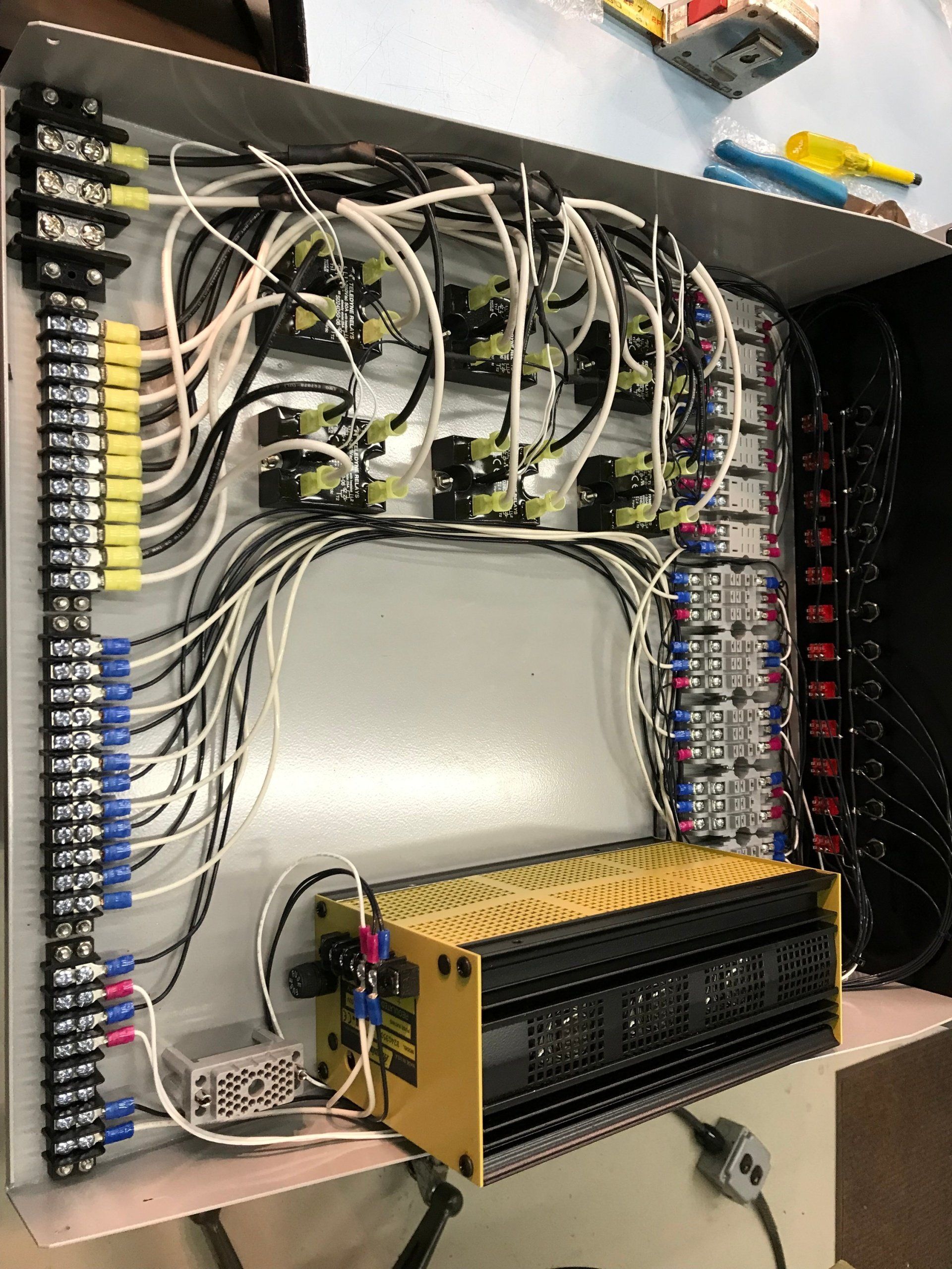 A box with a lot of wires coming out of it.