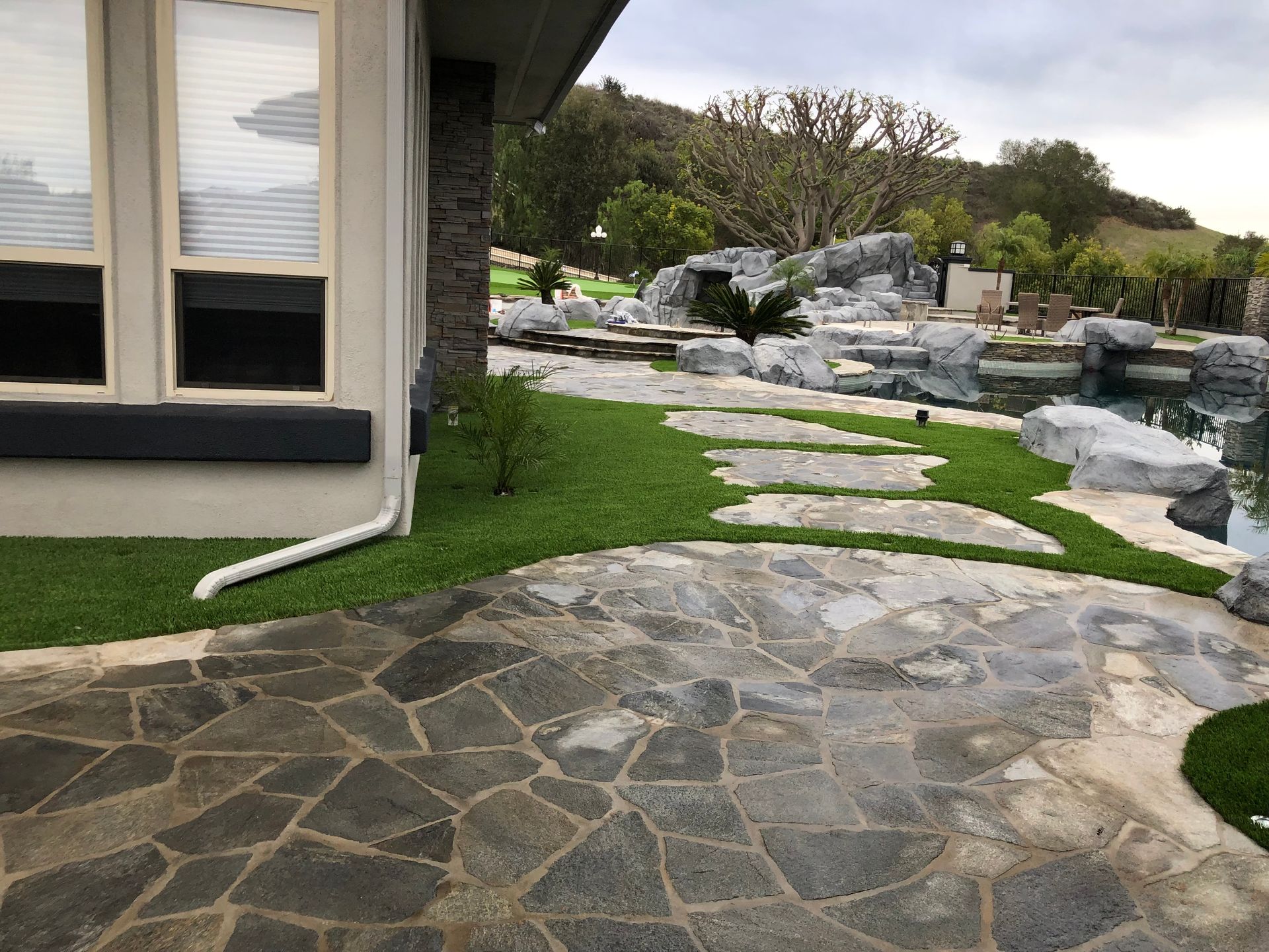 artificial grass and rock pavers