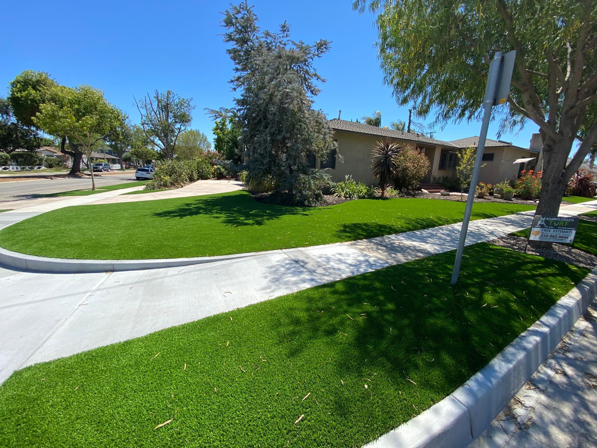 synthetic grass on the sides of driveway