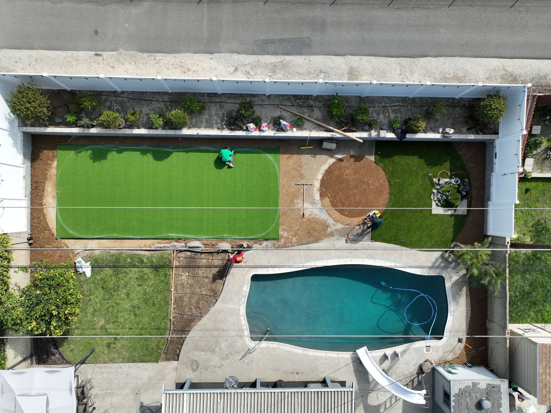step stones, pool and artificial grass
