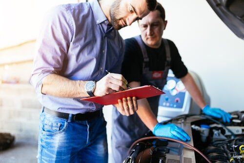 Man is Holding a Clipboard — Kirk Auto Know Mechanical in Stuart, QLD