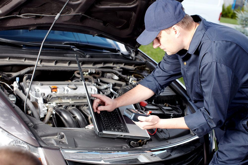 Car Mechanic Using Laptop β Kirk Auto Know Mechanical in Stuart, QLD