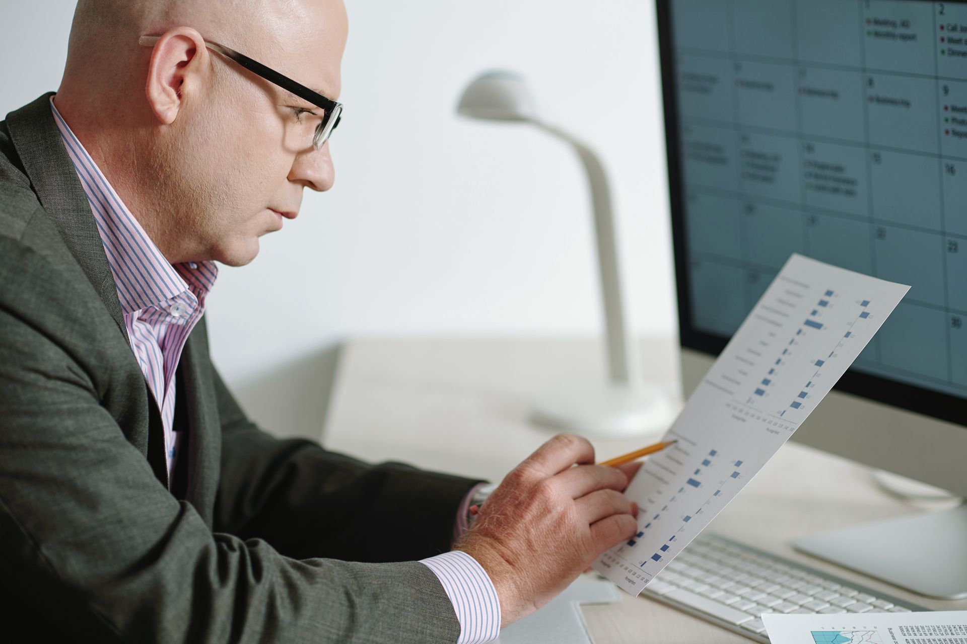 Professional reviewing financial documentation for Above Guideline Increase application in Ontario